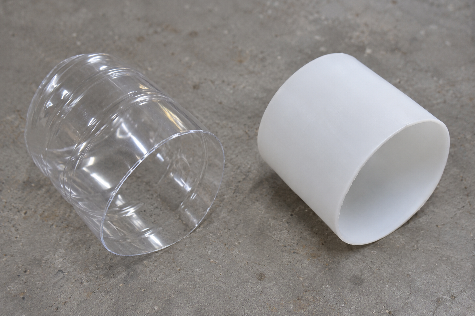 Cut edges of a clear PET wall and an opaque HDPE wall, with no scale